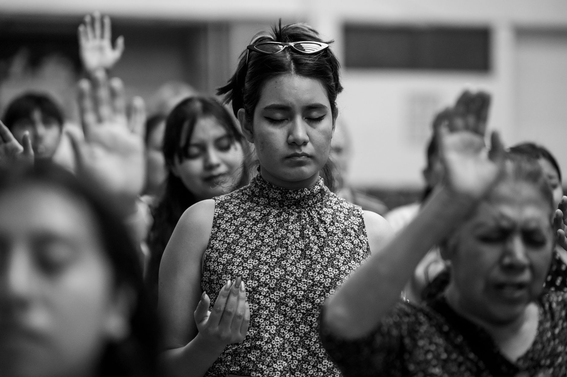 woman among praying people at house of worship